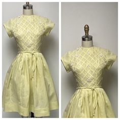 1950's sunny yellow fine organdy or batiste summer dress, with short sleeves, fitted bodice, and full skirt. The sleeves are self faced with piping accents, also at the round neckline. Bias folds create a lattice design on the front bodice, with floral appliques and rhinestones. There is a double corded waist tie. On the far left and far right, the rhinestones have been replaced, but don't look the same. There is a fine nylon tulle under slip that adds just a bit of poof. there is one pin hole o Yellow A-line Vintage Dress For Summer, 1950s A-line Vintage Summer Dress, Yellow Fitted Short Sleeve Dress, Short Sleeve Vintage Fashion Dresses For Spring, Spring Vintage Fashion Short Sleeve Dresses, Spring Yellow A-line Vintage Dress, Vintage Fashion Spring Dress With Short Sleeves, Fitted Short Sleeve Dress For Vintage Events, Retro Vintage Dress For Spring Events