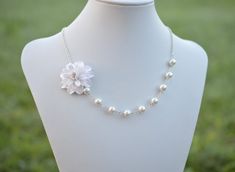 "The Listing is for 1 Dahlia Necklace. There are 2 colors to choose from : White Dahlia ( go with White Glass Pearls) or Ivory Dahlia ( go with Ivory/ Cream Glass Pearls) NOTE : if you prefer different color other than white or Ivory color, please drop a note or convo me when you check out. Variety Dahlia Flower Necklace and Jewelry available in my shop, if you do not find in the listings, feel free to contact me. * Hand Sculpted Dahlia. Size; approx ; 1.5\" * 8mm Ivory/cream/Offwhite Glass pear White Flower Jewelry For Bridesmaid Gift, White Floral Jewelry For Bridesmaid Gift, White Pearl Jewelry With Flower Decoration, Pearl Flower Necklace For Wedding, Pearl White Flower Necklaces For Wedding, White Flower Pendant Necklace For Wedding, White Pearl Flower Necklace For Weddings, Elegant Handmade White Flower Necklace, Delicate White Bridal Necklace For Bridesmaid Gift