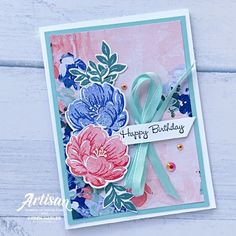 a close up of a greeting card with flowers on it and a ribbon around the edge