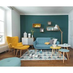 a living room with blue walls and yellow chairs