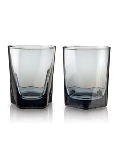 two glasses sitting next to each other on a white surface