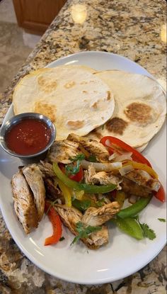 a white plate topped with meat and veggies