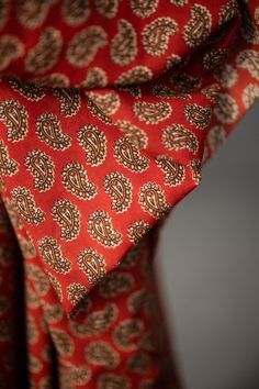 a red tie with brown designs on it