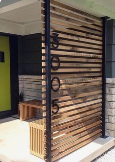 a wooden bench sitting in front of a green door