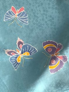 three butterflies on a blue background