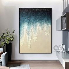 an abstract painting hangs on the wall in a modern living room