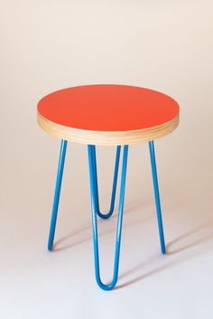 an orange table with blue legs on a white background