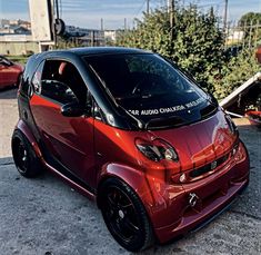 the smart car is parked on the side of the road