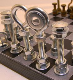 a chess board with nuts and bolts on it