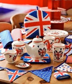 the table is covered with british flags and teapots