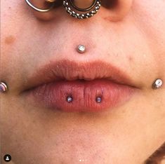 a woman with piercings on her nose