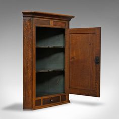 an old wooden cabinet with its doors open