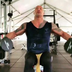 a man sitting on top of a bench in a gym