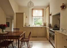 a kitchen filled with lots of furniture next to a window