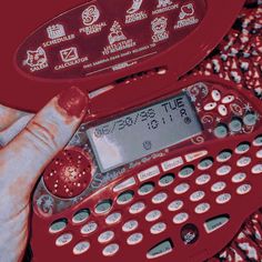 a person holding a red typewriter in their hand