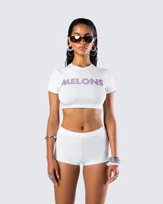 Show off the melons in this white graphic top 😜 This top, made from jersey fabric and complete with a pink “MELONS” rhinestone graphic, will have everyone craving some fruit 🍈 White Graphic Print Stretch Crop Top, Stretch White Crop Top With Graphic Print, White Crop Top For Summer Streetwear, Stretch Graphic Tee Crop Top For Summer, White Graphic Print Crop Top For Summer, White Graphic Tee Crop Top For Summer, White Rhinestone Top, Keds Style, Future Of Fashion