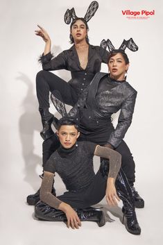 three women in black outfits posing for a photo with bunny ears on their head and legs