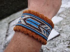 Native American bracelet deerskin . The leather is lined and offers an incomparable comfort. I beaded on a loom and sewn piece on the wristband . The button is in antler and I left extra length of lace to allow you to yaw adjustment. This bracelet will fit a wrist as 6 inches or more. If you want other length or other colors, please , send me a request for personalization. The black and white version shown on the last picture is available here: https://www.etsy.com/ca-fr/listing/536664563/bracel Seed Bead Loom, Antler Buttons, Bead Loom Bracelet, Beaded Hat Bands, Native American Men, Native American Bracelets, American Men, Beaded Hat, Loom Bracelet