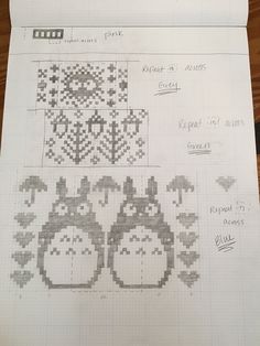 some type of cross stitch pattern on top of a piece of paper