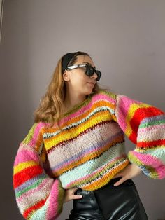 Elevate Your Wardrobe with Our Colorful Striped Sweater Introducing our Colorful Striped Sweater, a true masterpiece of hand-knitted warmth and style. This oversized, unisex sweater is a celebration of color and comfort, making it the perfect addition to your seasonal wardrobe. **Features 🌈 **Vibrant Stripes Our Colorful Striped Sweater boasts a playful and eye-catching design with a blend of striking colors. It's a statement piece that exudes confidence and personality. 🧶 **Hand-Knitted Craftsmanship Each sweater is meticulously hand-knitted with care and precision, ensuring a high level of craftsmanship and quality that's meant to last. 🧥 **Versatile Fashion Whether you're lounging at home, heading out for a chilly adventure, or adding a pop of color to your everyday attire, this swea Retro Chunky Knit Fall Sweater, Retro Chunky Knit Sweater For Fall, Casual Multicolor Knitted Cropped Sweater, Stretch Acrylic Chunky Knit Sweater, Retro Knitted Acrylic Sweater, Cozy Multicolor Knitted Top, Retro Knit Stretch Sweater, Bohemian Chunky Knit Winter Top, Bohemian Chunky Knit Top For Winter