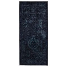 a dark blue rug with an ornate design on the front and back side, in two different colors