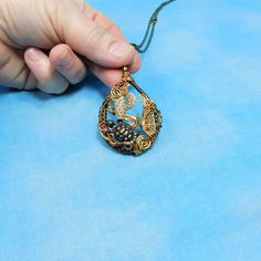 A bronze desert tortoise, along with a bronze cactus, are framed with three shades of hand woven non tarnish copper wire, creating a 2 inch by 1 1/2 inch pendant style necklace. The tortoise ambles against an artistic desert landscape with swirling wire suggesting rolling tumble weeds in a tiny Southwestern theme work of art. The pendant comes with a FREE coordinating chain with lobster claw clasp, measured to your preferred length. Your unique pendant is ready to ship via USPS to your US locati Handmade Adjustable Antique Gold Necklace, Handmade Artisan Bronze Necklace, Handmade Artisan Bronze Jewelry, Handmade Antique Gold Pendant Necklace, Artistic Bronze Collectible Necklaces, Artistic Handmade Brown Necklace, Artistic Bronze Collectible Necklace, Antique Finish Brown Jewelry Gift, Decorative Bronze Pendant Jewelry