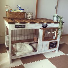 a dog is sitting in his cage on the floor