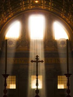 the sun shines through two windows in a church