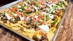 a tray filled with food sitting on top of a wooden table