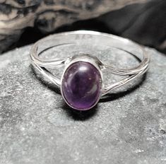 These rings are old store stock- unworn.They are top quality vintage amethyst set in .925 sterling silver. Amethyst is used as a protection stone and is said to lessen stress and negative energy. The stone is about 1/4 of a inch tall or 7 by 5 mm. This retailed at $52. It comes in a tiny ring box. Classic Amethyst Oval Cabochon Ring, Classic Silver Amethyst Oval Cabochon Ring, Classic Silver Amethyst Ring Oval Cabochon, Classic Amethyst Cabochon Ring, Classic Silver Amethyst Ring With Oval Cabochon, Classic Silver Oval Cabochon Amethyst Ring, Classic Cabochon Amethyst Ring, Formal Purple Amethyst Spiritual Ring, Formal Spiritual Amethyst Ring