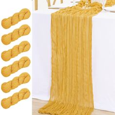 the yellow blanket is next to several pieces of yarn on top of a white table cloth