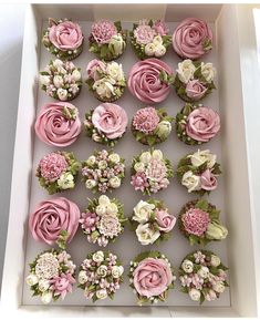 a box filled with lots of pink and white flowers