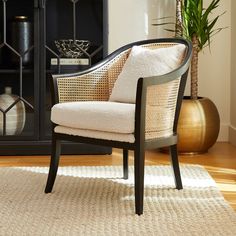 a chair sitting on top of a wooden floor next to a fire place in a living room