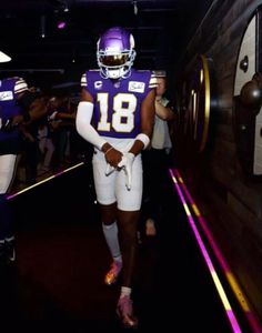 a football player is walking down the tunnel