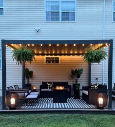 an outdoor living area with couches and lights