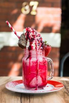 a drink with strawberries and ice cream on a plate