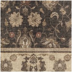 an area rug with floral designs on the bottom and brown, beige, and white colors