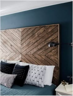 a bedroom with blue walls and wooden headboard