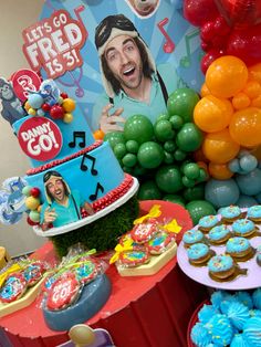 there is a cake and cupcakes on the table