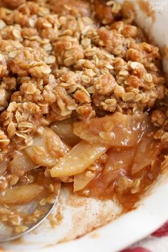 a bowl filled with apple crisp on top of a table