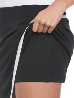 Featuring a flattering wrap design and eye-catching color blocking, this women’s golf skort from Callaway will be a striking addition to your athletic wardrobe. The skort is made from an interlock knit fabric that offers natural stretch to let you bend and twist without feeling constricted. The material has sun protection technology to help block harmful UV rays, and it wicks away moisture to help keep you comfortable and dry. Truesculpt™ technology helps to create a smoother, more streamlined s Sporty Black Tennis Shorts, Short Athleisure Tennis Dress, Short Tennis Dress For Sports, Black Stretch Tennis Shorts, Black Stretch Shorts For Tennis, Black Athleisure Tennis Skort, Black Athleisure Skort For Tennis, Sporty Mini Tennis Dress, Black Mini Skort For Athleisure