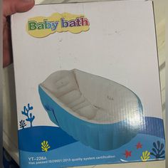 a baby bath is in the box with its lid open