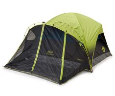 a green and black tent sitting on top of a white floor