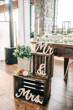 a wooden box with the word mr and mrs on it sitting in front of a table