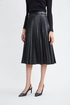 Versatile and undeniably chic, our Vegan Leather has the luxe touch and patina we wanted for our pleated midi skirt. With its gold buttons at the waist, it has the cool factor you are looking for. Pair it with our body skimming knits or soft blouses for an effortless day-to-dinner look. T-Tahari Vegan Leather Pleated Midi Skirt 100% Polyurethane Runs true to Size Model is 5'9" and wearing size S Dry Clean Only Imported Style #: THF49029 Long Sleeve Short Dress, Black Midi Skirt, Elie Tahari, Pleated Midi Skirt, Knit Tees, Denim Coat, Knit Jacket, Gold Buttons, Our Body