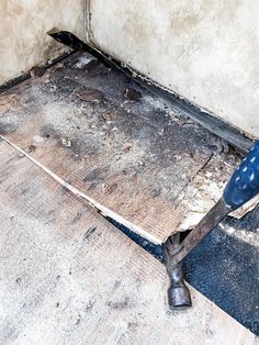 a person is using a tool to clean the floor