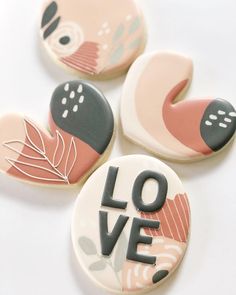 four decorated cookies with the words love on them