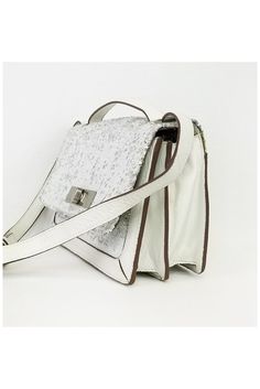 This leather crossbody is designed with white and silver sequins. A great day to night bag, it has multiple interior compartments. Comes with an adjustable crossbody strap for versatility. 70% Leather, 30% acrylic Fold over top closure Turn lock front closure Sequins on front Adjustable shoulder strap 2 interior open pockets 1 interior zip pocket Silver-tone hardware Width 10.75" Height 6.75" Depth 2.5" Strap drop White Crossbody Shoulder Bag With Silver-tone Hardware, White Leather Shoulder Flap Bag, White Leather Shoulder Bag With Magnetic Closure, White Crossbody Flap Bag With Detachable Strap, White Party Bag With Silver-tone Hardware, White Crossbody Shoulder Bag With Magnetic Closure, White Flap Bag With Magnetic Closure For Evening, White Leather Flap Bag For Evening, White Evening Flap Crossbody Bag