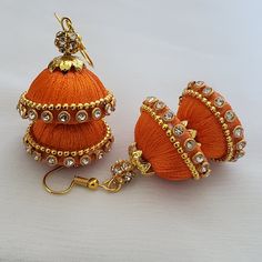 "Handmade earrings wrapped with shiny silk thread with two domes(2.5cm diameter and 2cm diameter).  Now available in holiday colors!  Customization available as well. These earrings are called \"Jhumkas\" in India signified by the dome shape of the hanging, these earrings come in many colors and sizes. These silk thread type will be custom made just for you after you place your order. you can mix and match colors, and you can request earring sets of one color or mix two colors. (look at the image of the cluster of domes, there are two colors in the same earring)  1) Your choice of color/s. Available colors:  orange, gold, white, pink, black, brown , beige,  purple, light green/dark green ( please specify which green in your request) , light blue/dark blue (specify which blue), light red/da Silk Thread Jhumkas, Silk Thread Earrings Designs, Silk Earrings, Silk Thread Necklace, Silk Thread Earrings, Diy Wire Earrings, Diy Jewellery Designs, Orange Jewelry, Silk Jewelry