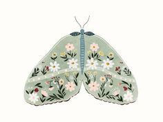 a green butterfly with white and pink flowers on it's wings, sitting in front of a white background